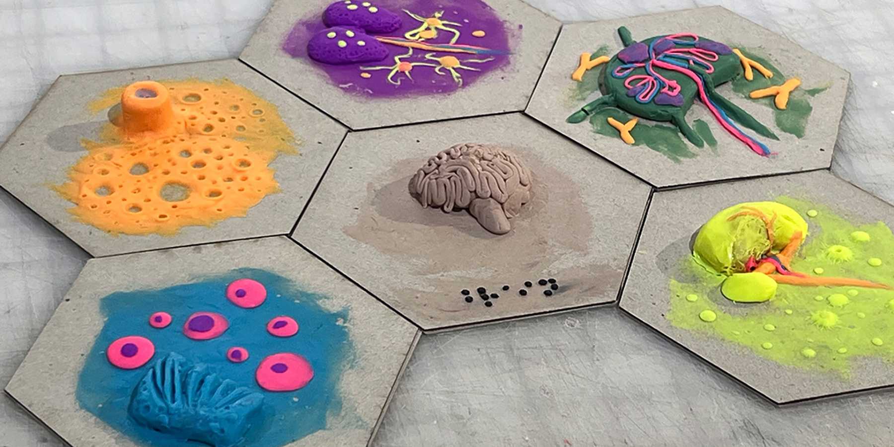 1st iteration tiles made by hand with colorful modelling polymer clay and paper cardboard