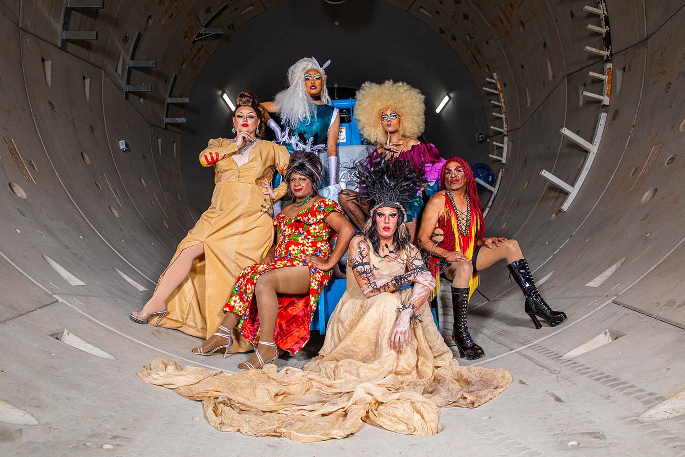 Six indigenous drag queens dressed in costume photographed in a tunnel