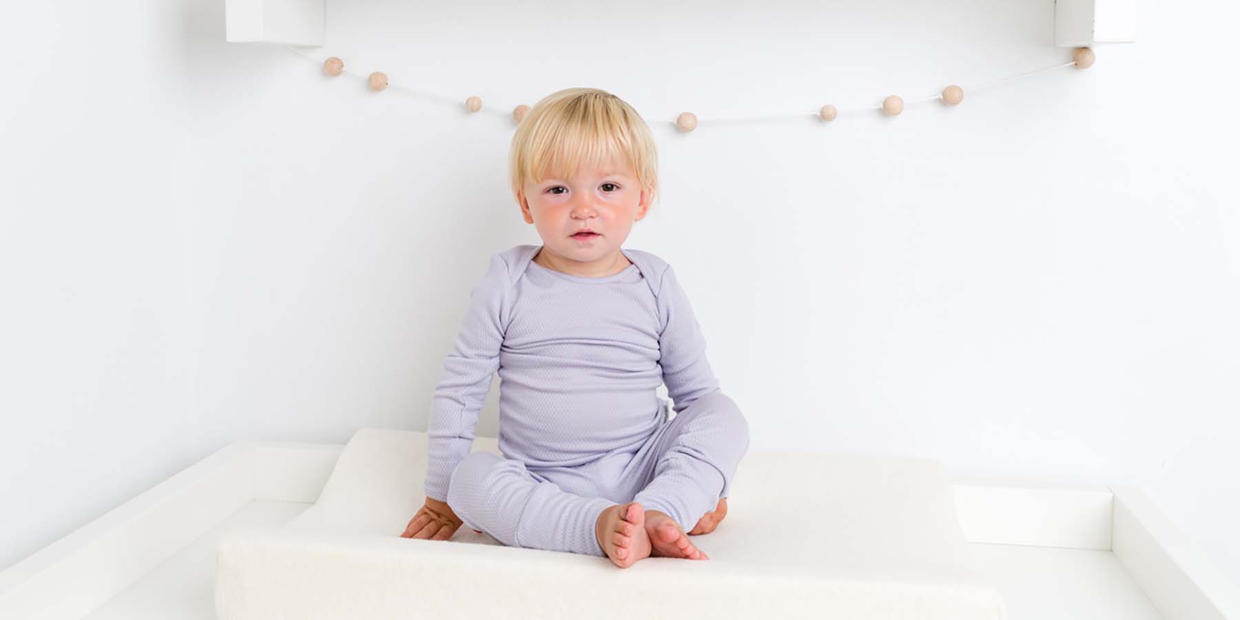 Baby dressed in Merineo's pure superfine merino wool long sleeved top and leggings.