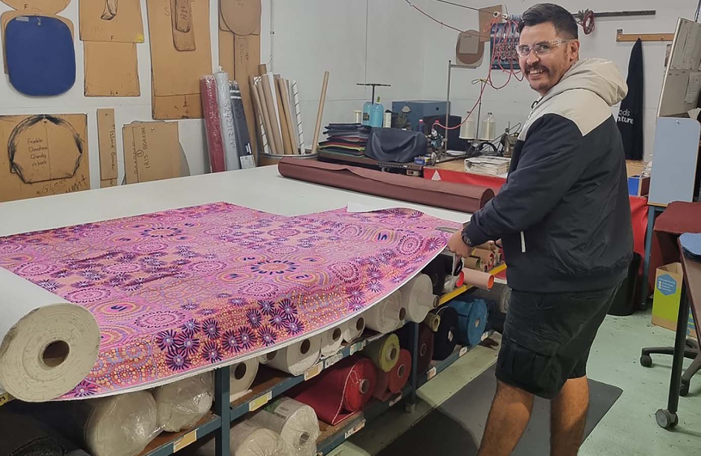 Artist Steven Bekue with one of the fabrics he designed 