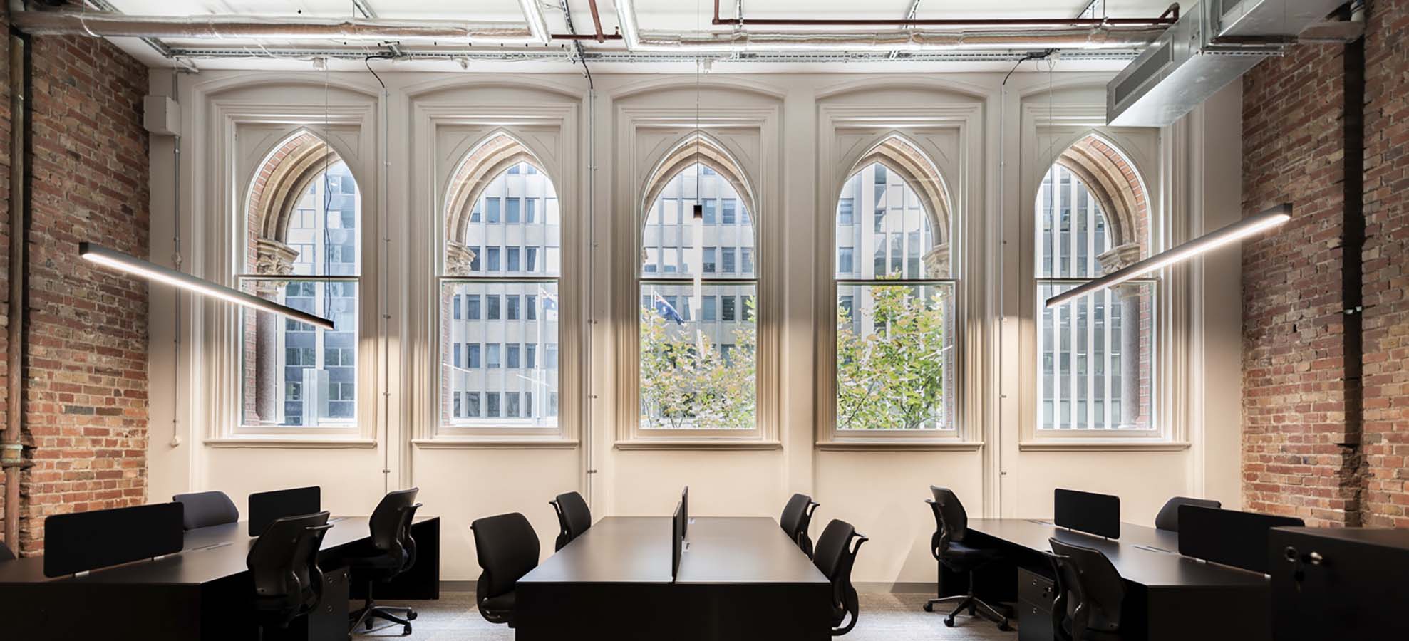 A refurbished heritage space with workstations and views to Collins Street. Photo by Kenneth Li