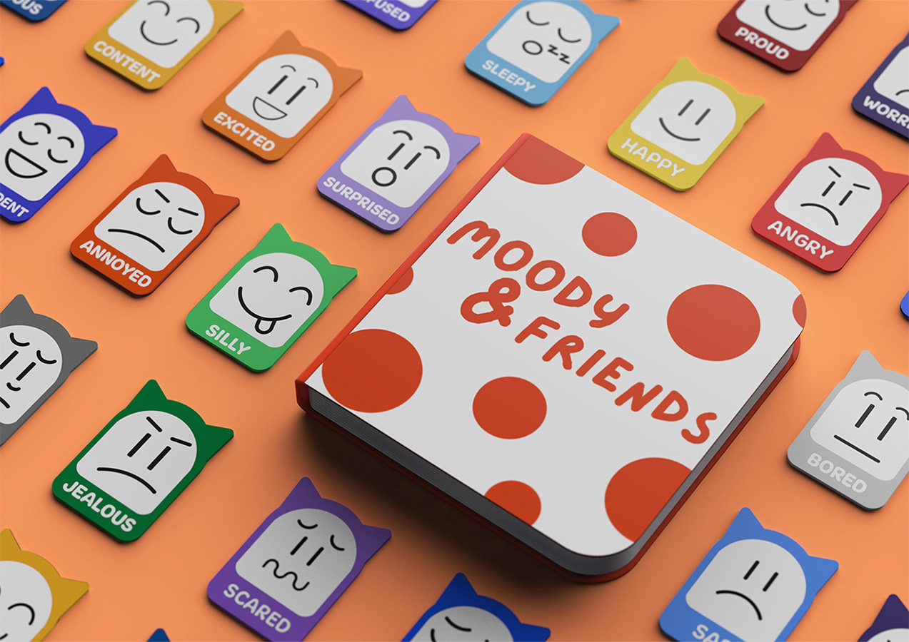Moody and Friends storybook lies centered, surrounded by emotion cards showing various colorful emotions and expressions.