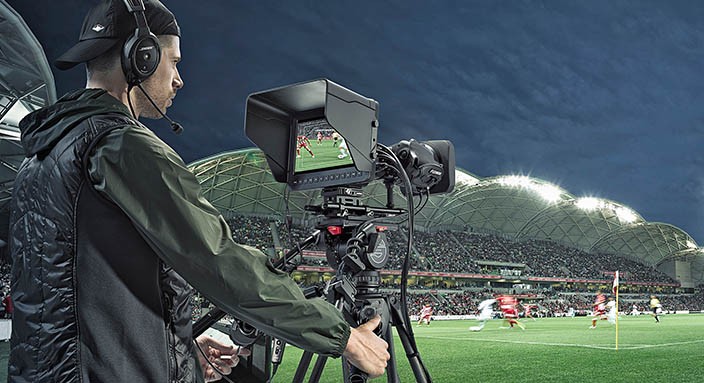 Person using the Blackmagic Studio Camera in a sports stadium