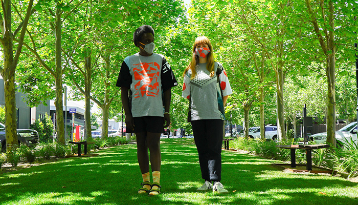 Two people walking in park with uniform on