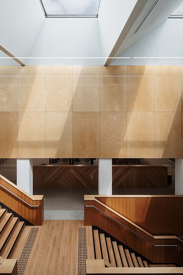 Interior view of the central stair and atrium featuring timber finishes and natural daylight.