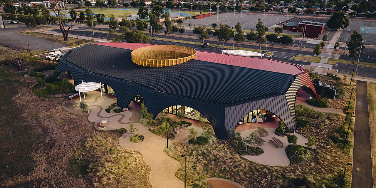 Aerial view of the Munarra Centre for Regional Excellence at dusk.