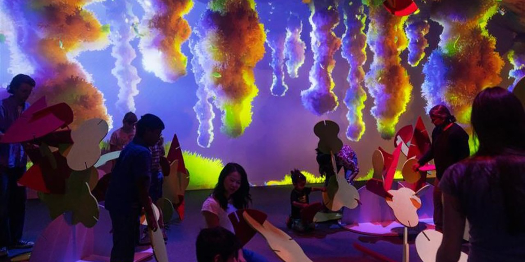 A group of exhibition visitors building with colourful shapes in an ant pantry