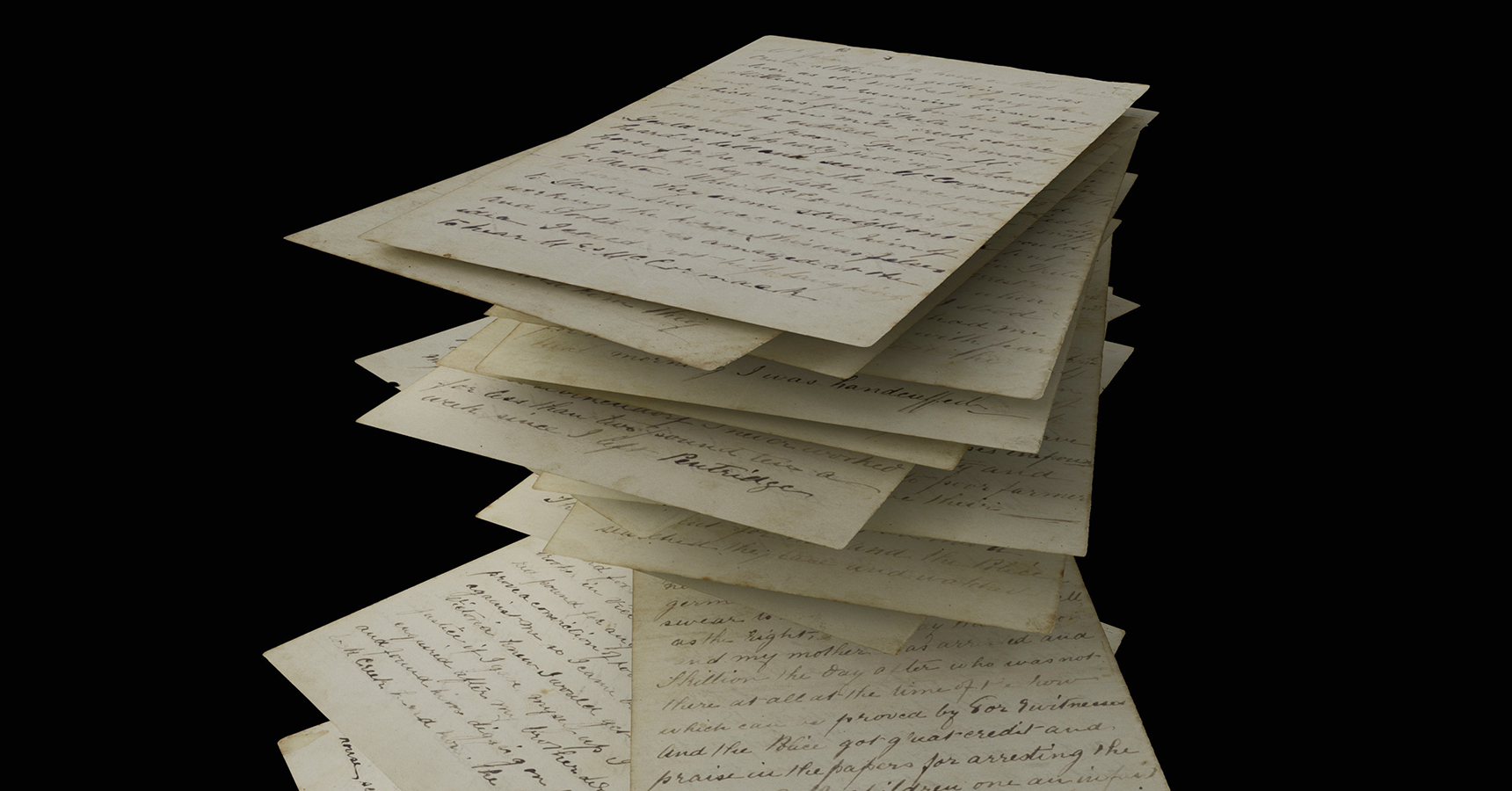 Handwritten papers floating on black