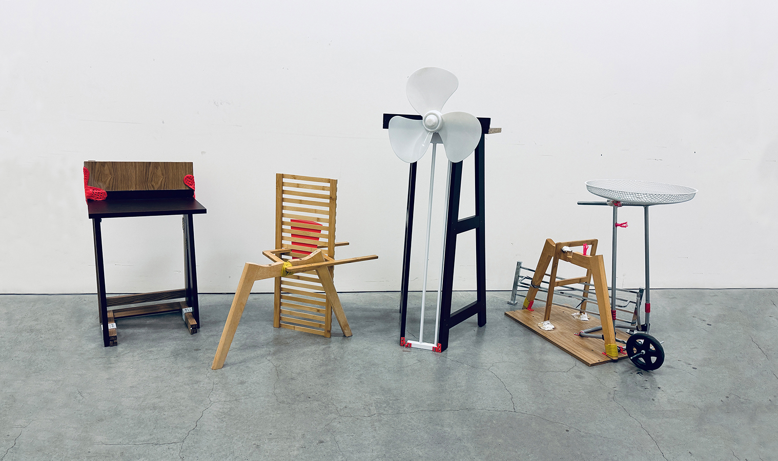 Four reused furniture pieces—chair, shelf, lectern, and side table—assembled using salvaged parts and 3D-printed joints.