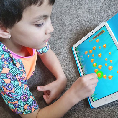 child playing on tablet