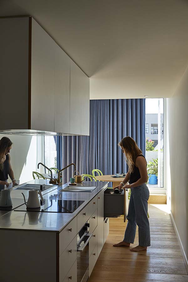 Terrace House, interior apartment with galley kitchen. Photo by Derek Swalwell