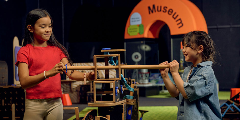 Two exhibition visitors inventing something together