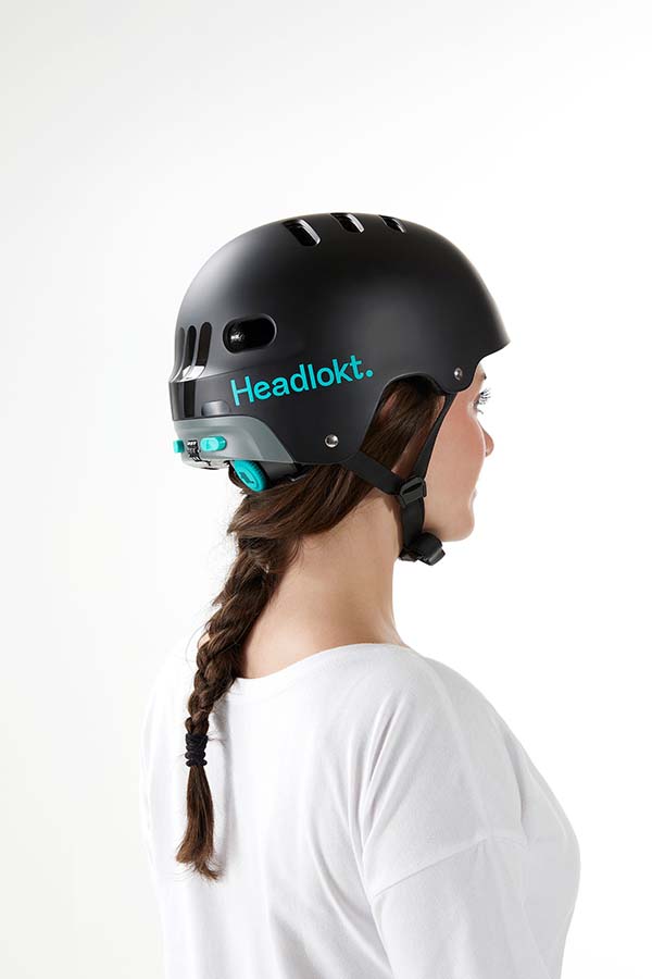 Rear-side view of black Headlokt OneLock helmet worn by a cyclist