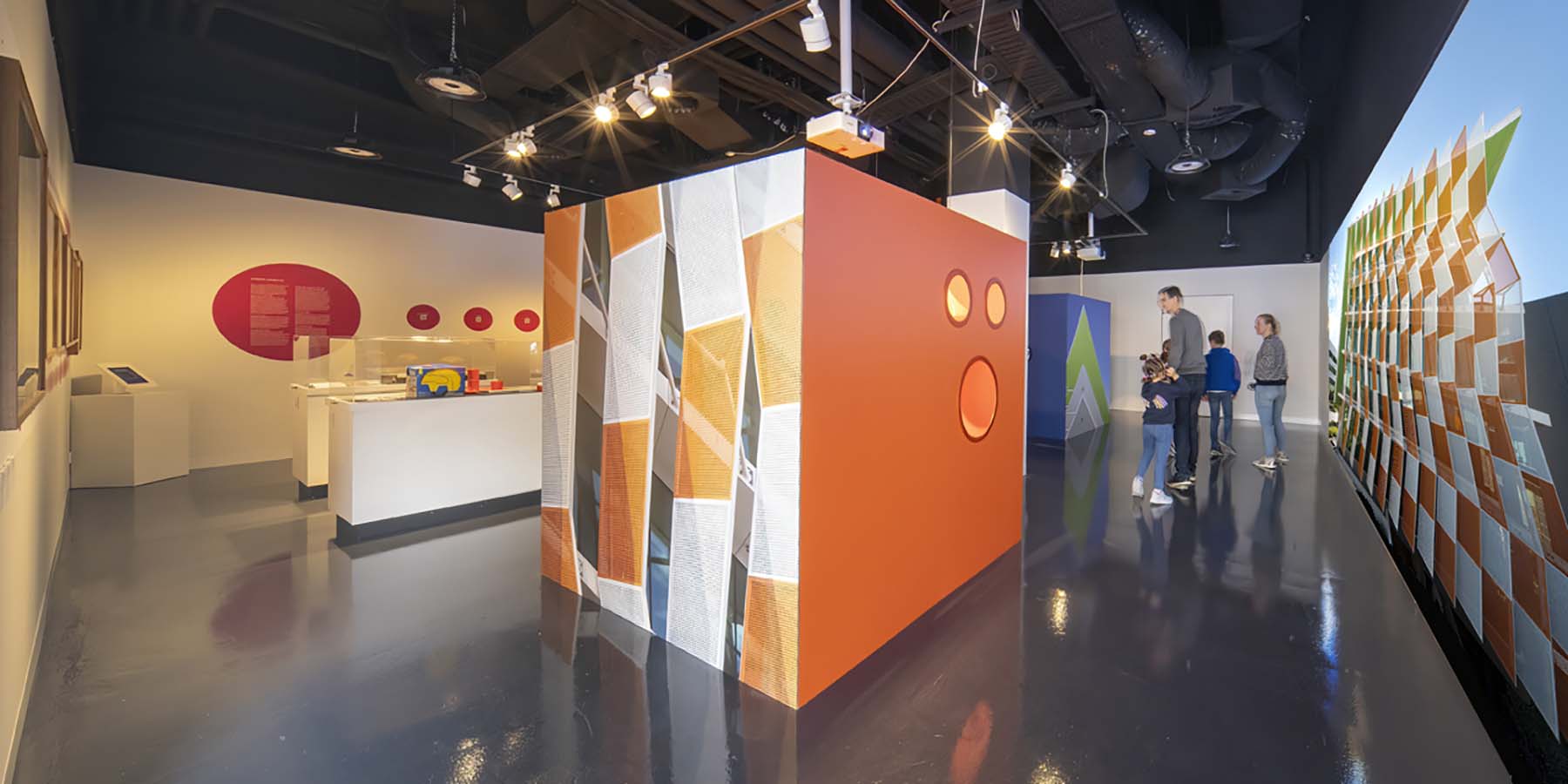 Light Colour Humanity exhibition at CMAG. View of orange and blue cubes, objects display and large digital projection.