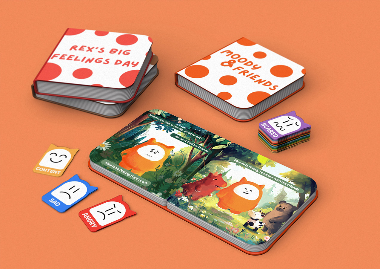 Three Moody and Friends storybooks from the emotion-learning ecosystem sit side by side, near colorful emotion cards.