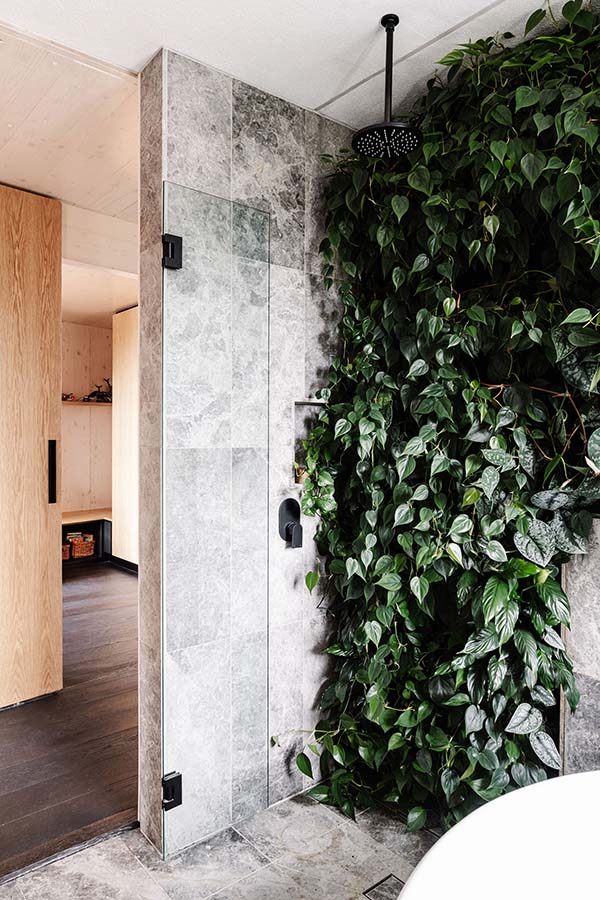 Bathroom with shower and living green wall. Photo by Marnie Hawson