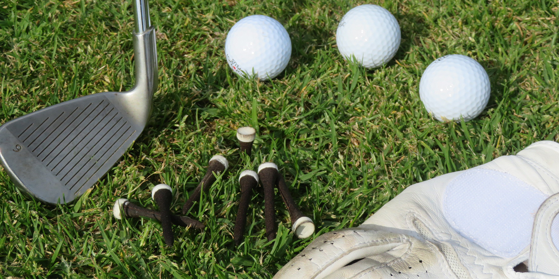 Grounds for grounds' biodegradable golf tee with various golfing equipment