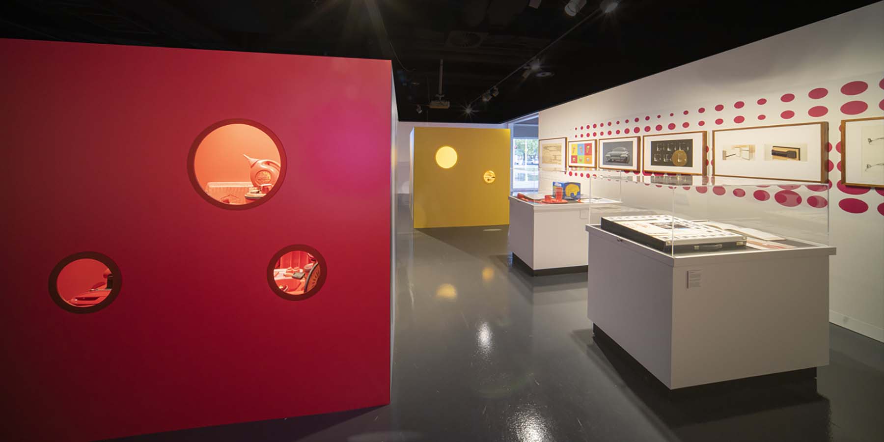 Light Colour Humanity exhibition at CMAG. View of red and yellow cubes, object display and original design drawings.
